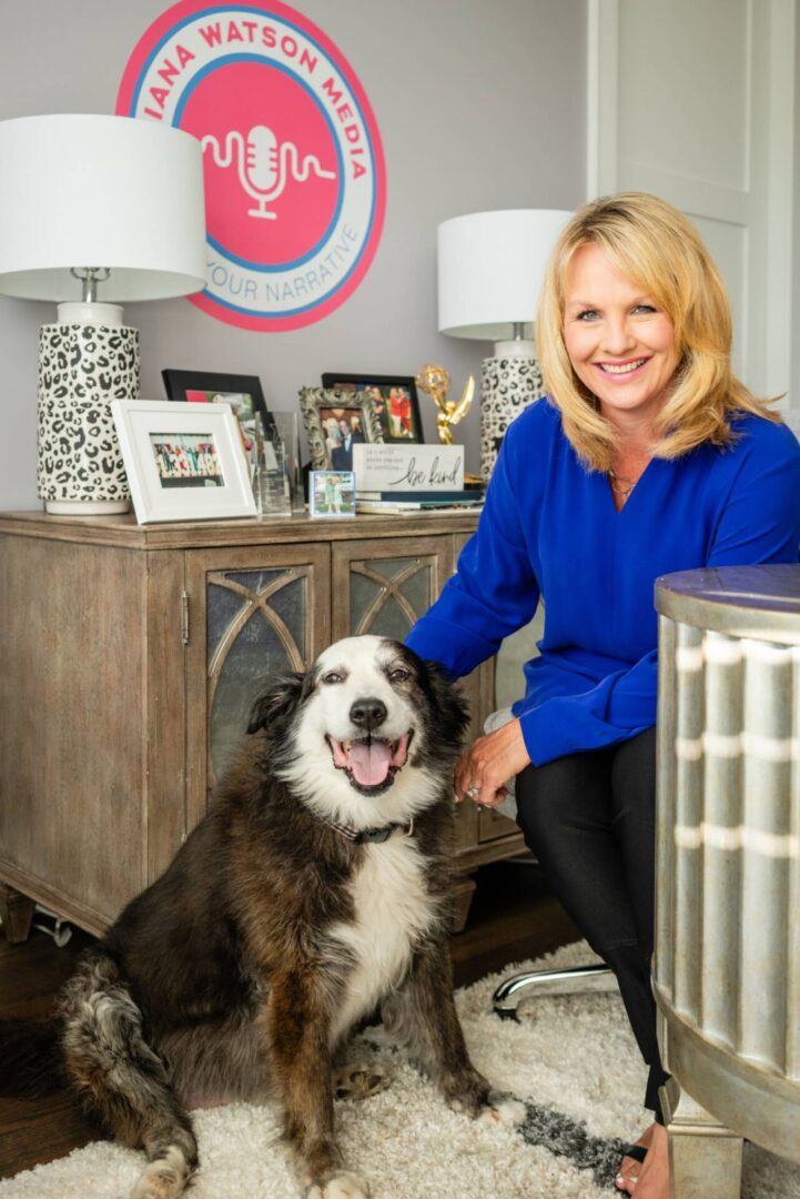 A woman and her dog in front of an air conditioner.